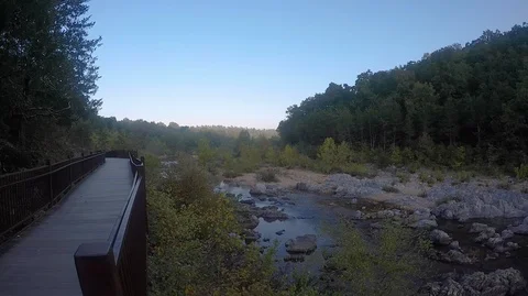 Nature trail next to a river in a forest Stock Footage 109558910