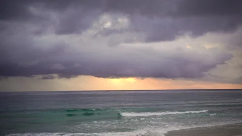 Nature video Mostly cloudy during the sunset. Rainstorms are falling into the Stock Footage 133351021