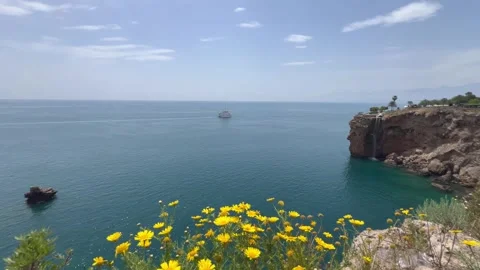 Nature view with a small waterfall falling to Mediterranean Sea Stock Footage 337114911