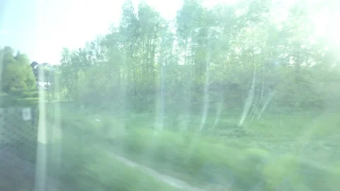 Nature view from the window of a carriage while traveling by rail, sunny day Stock Footage 163850880