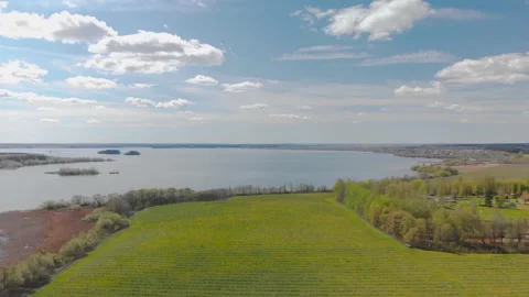 Nature views with lake, forest, field, clouds in a sunny day. Drone View. Video4 Stock Footage 131456751