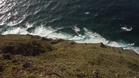 Nature's Dance: Waves Meet Rugged Coast Stock Footage 254421895