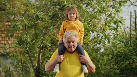 Nature's Gift: A child's hands, guided by her father's wisdom, nurture a Stock Footage 249652373