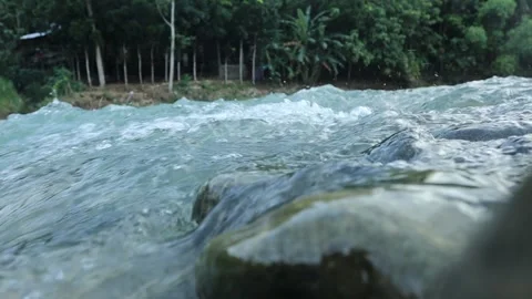 Nature's Tranquility: Graceful River Flow Over Pebbles in 4K Stock-Footage 241908552