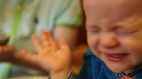 Naughty child during feeding porridge Stock Footage 59338534