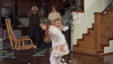 Naughty children throwing things around the house of grandparents. Grandmother Stock Footage 102936995