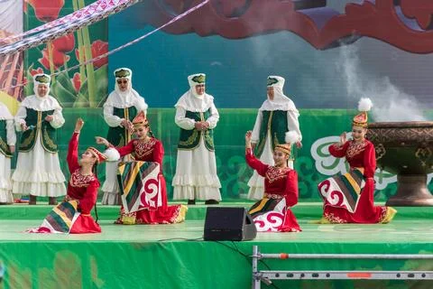 Nauryz holiday. Dancing with a patchwork blanket in hands. Photos