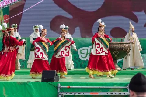 Nauryz holiday. Dancing with a patchwork blanket in hands. Photos