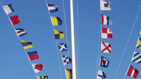 Nautical flags on the ship mast assign blue sky and windy day. Semaphore flags Stock Footage 150092169