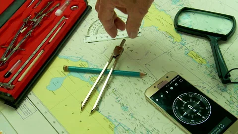 Nautical navigation instruments and chart plotting a course in the Caribbean sea Stock Footage 130558159