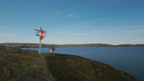Nautical navigational marker overlooking the calm waters of Bodega Bay Stock Footage 326374541