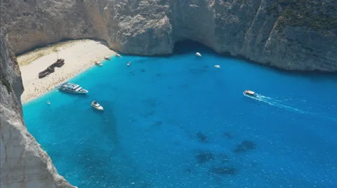 Navagio beach bay with blue water and boats Stock Footage