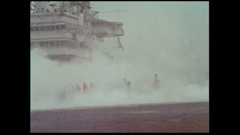 A naval officer releases a white balloon into the air as the ship deck turns Stock Footage