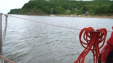Navigating the Amur river Close-Up View of a Sailor Adjusting Lines on a Yacht Stock Footage 304965914