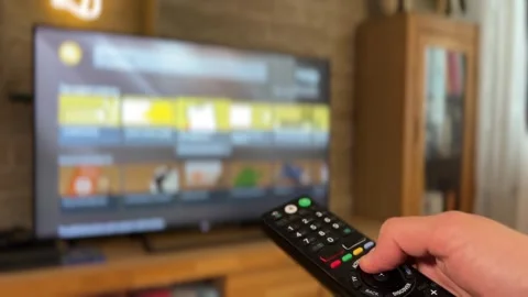 Navigating Content Options on Remote Screen Stock Footage 310139090