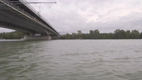 Navigating the Danube under a bridge Stock Footage 116193065