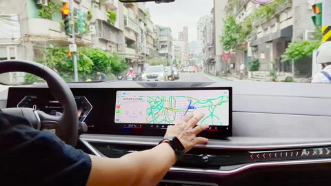 Navigating the Journey: Driver Setting GPS Route While Waiting at Red Light Stock Footage 293468907