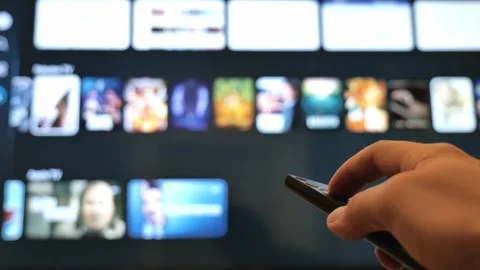 Navigating Online Streaming Platform Interface with Hand Held TV Remote. Stock Footage 345719041