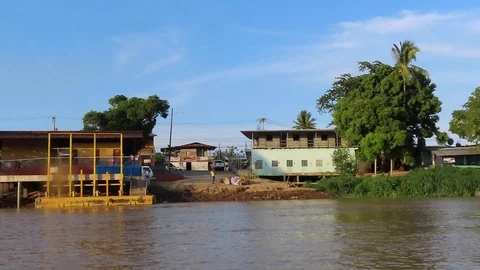 Navigating on a river passing by a small town Stock Footage 111234044