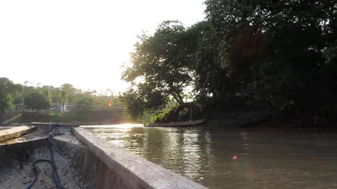 Navigating on a river passing by trees and houses 2 Stock Footage 111234007