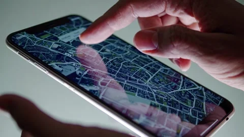 Navigating through a detailed map on a mobile device in an urban area during the Video stock 296414328