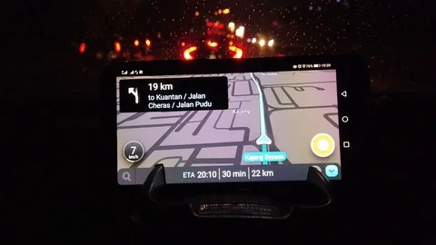 Navigation app using smartphones at the top of the car dashboard at night Stock Footage 105989445