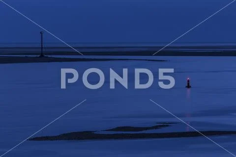 Navigation buoy in the Conwy estuary at dusk on the North Wales coast Stock Photos