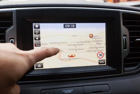 Navigation panel inside a car. Finger pointing on destination point. Stock-Fotos