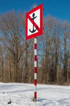 Navigational river sign. No mooring sign on the river with winter landscape. Stock Photos