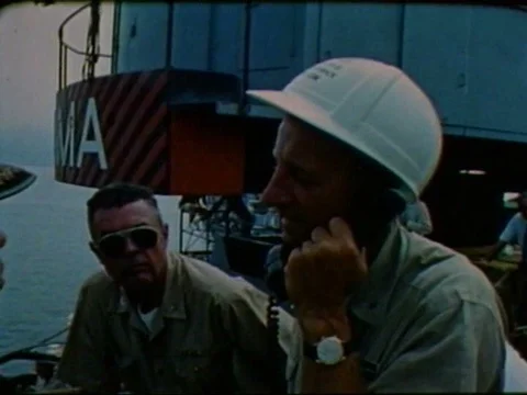Navy divers check into a leak as Sea Lab II is lowered into the ocean in theƒ Video stock 75298979