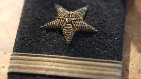 Navy Embroidered Patch On Table Close Up Tilt Down Stock Footage 145510612