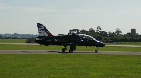 Navy fighter plane moving down runway Stock Footage 41372821