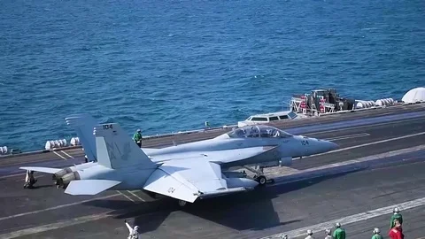 Navy jets take off from a U.S. aircraft carrier. Stock Footage 84329292
