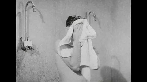 Navy man taking shower while talking to his friend - 1945 Stock Footage 101407302