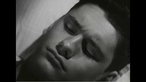 Navy man trying to sleep on bed - 1945 Stock Footage 101407440