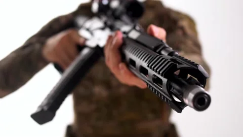 A Navy SEAL sergeant vest aims a combat automatic rifle at the camera Stock Footage 158017429
