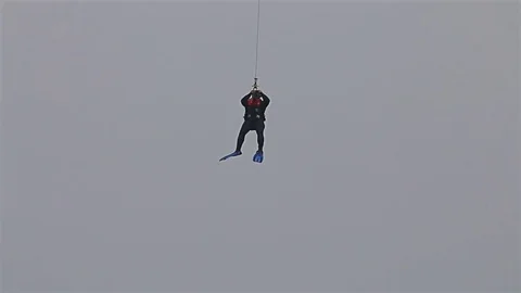Navy seals training rescue people in the open sea with flying helicopter Video stock 77123875