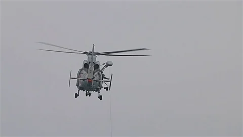 Navy seals training rescue people in the open sea with flying helicopter Видео 77124284