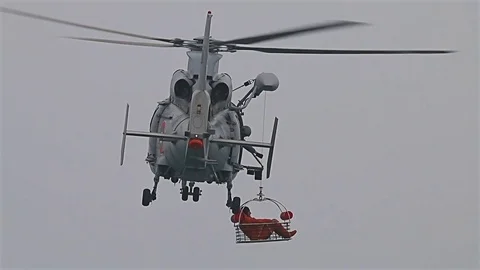 Navy seals training rescue people in the open sea with flying helicopter Stock-Footage 77124345