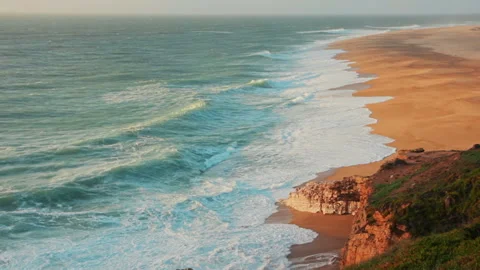 Nazare beach panoramic view with splashing waves Stock Footage 99056108