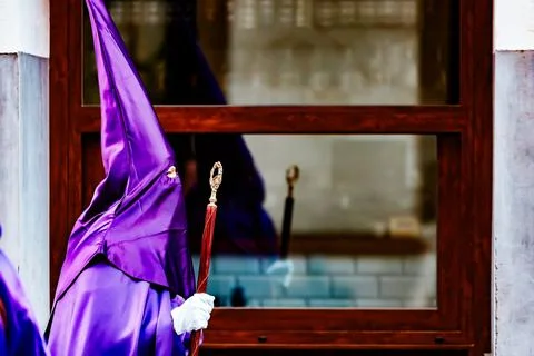 Nazarenes and their reflection in the procession of Good Friday in Villajoyos Stock Photos
