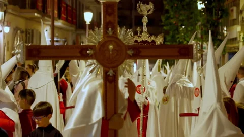 Nazarenos processing with cross during Holy Week in Spain Stock Footage 334808492