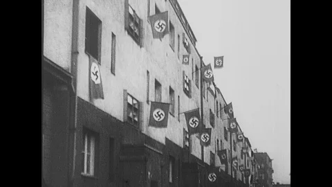 Nazi flags are compared with white flags of surrender now hanging from buildings Stock Footage 103382782