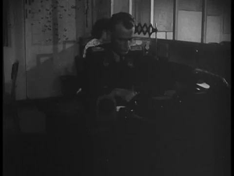 A Nazi at a state-of-the-art air plotting center answers a phone and talks in Vídeos de archivo 75291600