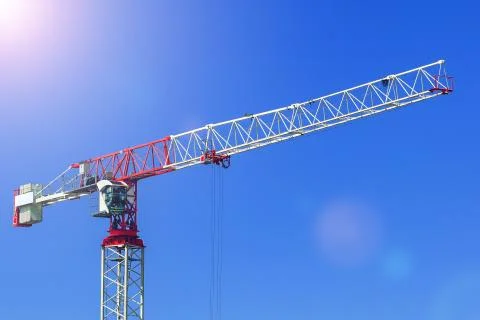 Ndustrial construction crane or column-jib crane with cabin works on the Stock Photos