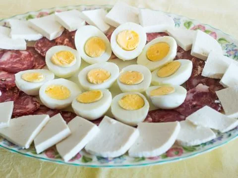 Neapolitan easter refreshment with eggs and salami Stock Photos