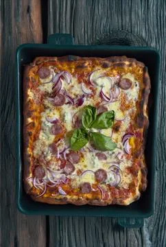 Neapolitan rectangular pizza with tomatoes, mozzarella, onions and sausage Stock Photos