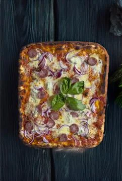 Neapolitan rectangular pizza with tomatoes, mozzarella, onions and sausage Stock Photos