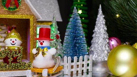 Near the Christmas tree branches decorated with garlands there is a house Stock Footage 340217680