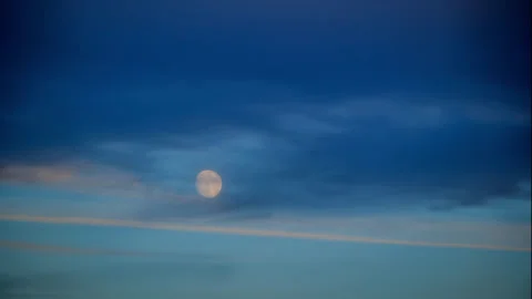 Near Full Moon Rises through Light Clouds Stock Footage 285042157